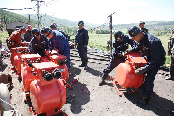 Rescuers work at the scene where a colliery flood trapped 24 workers in Northeast China's Heilongjiang province, August 1, 2010.