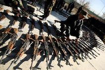 An Afghan officer checks guns during a handover ceremony in the Afghan capital Kabul, Dec. 23, 2009. Afghan anti-terrorism department handed over 85 AK-47 rifles and ammunition to the Disarmament of Illegal Armed Groups (DIAG) on Wednesday. The weapons were seized from illegal armed groups. (Xinhua/Zabi Tamanna)