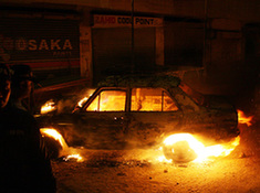 Blaze engulfs a car after a blast in a market in Karachi, Pakistan, Dec. 27, 2009. At least 16 people were injured in the blast. (Xinhua/Anwar Aabbas)