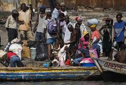 Local citizens try to flee this destroyed city by boat in Port-au-Prince, Haiti, Jan. 20, 2010. (Xinhua/David de la Pas)