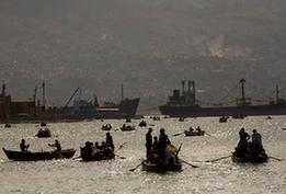 Local citizens try to flee this destroyed city by boat in Port-au-Prince, Haiti, Jan. 20, 2010. A 7.0 magnitude earthquake hit the country on Jan. 12, 2010. (Xinhua/David de la Pas)