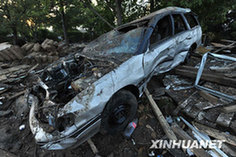 Photo taken on March 2 shows a car wreck after a quake-triggered tsunami swept across Constitución in southern Chile on Feb. 27, 2010. [Song Weiwei/Xinhua]