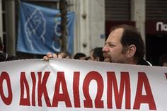 A protestor holds banner outside the building of Greek Finance Ministry in Athens, capital of Greece, March 4, 2010. A group of labor union members protest against the new round of austerity measures announced by the government outside Greek Finance Ministry on Wednesday. [Marios Lolos/Xinhua]