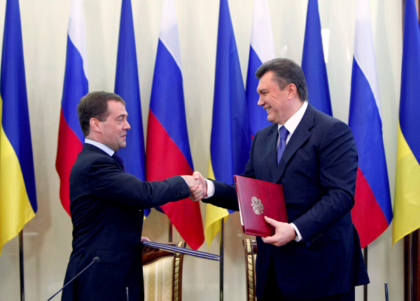 Russian President Dmitry Medvedev (L) and his Ukrainian counterpart Viktor Yanukovych shake hands after signing documents in the eastern Ukrainian city Kharkiv April 21, 2010. The two countries agreed Wednesday to extend Russia's Black Sea Fleet stay in Ukraine beyond 2017 expiry date. [Andrey Mosienko/Xinhua]