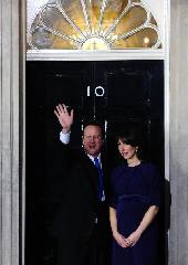 Britain's new Prime Minister Conservative party leader David Cameron (L) and his wife Samantha arrive at 10 Downing Street in London, on May 11, 2010. Cameron was appointed by Britain's Queen Elizabeth II as new prime minister. 