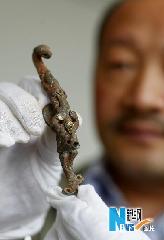 Photo taken on May 14, 2010 shows an unearthened artifact at the excavation site of the tomb of Cao Xiu, a noted general from the Three Kingdoms period (220-280 A.D.) in Mangshan of Luoyang City, central China's Henan Province. Archeologists of Henan provincial cultural heritage bureau confirmed that they have founded the tomb of Cao Xiu during the tomb excavation in Mengjin County of Luoyang City at a press conference on Monday. [Xinhua photo]