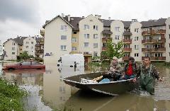 People use a boat to transport goods in the flooded district of Wroclaw May 24, 2010. [Xinhua/Reuters]