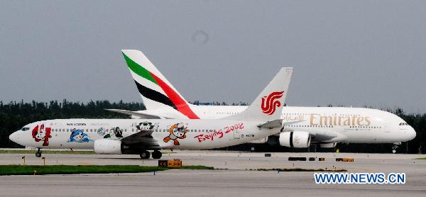 Emirates Airlines&apos; A380 passenger plane (R) of the United Arab Emirates (UAE) arrives at the Capital International Airport in Beijing, capital of China, on Aug. 1, 2010. Emirates Airlines launched its first A380 service in China, flight EK306/307 between Dubai and Beijing on Sunday. [Xinhua]