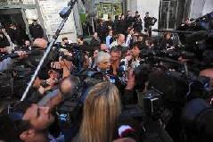 The lawyer of Italian Prime Minister Silvio Berlusconi, Giorgio Perroni (C), speaks to the press in front of Milan justice court during the first hearing of the 'Ruby the Heart Stealer' case's trial on April 6, 2011. Italian Prime Minister Silvio Berlusconi's trial on charges of sex with an underage prostitute, Karima El Mahroug, nicknamed 'Ruby the Heart Stealer', and abuse of power, opened and was immediately postponded by judges to May 31. 