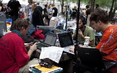 Protestors release news at a self-made press center in a park near the Wall Street in New York, the United States, on Sept. 27, 2011. After several streets around the Wall Street have been blockaded since Sept. 16, protesters pitched their tents at the Bowling Green and Battery Park to continue their demonstration.