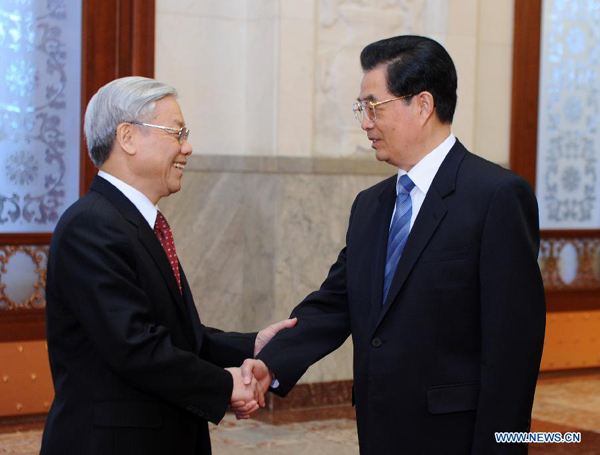 Chinese President Hu Jintao (R), who is also general secretary of the Central Committee of the Communist Party of China, meets with General Secretary of the Communist Party of Vietnam Central Committee Nguyen Phu Trong during a welcome ceremony in Beijing, Oct. 11, 2011. Nguyen Phu Trong arrived in Beijing on Tuesday, kicking off a five-day official visit to China.