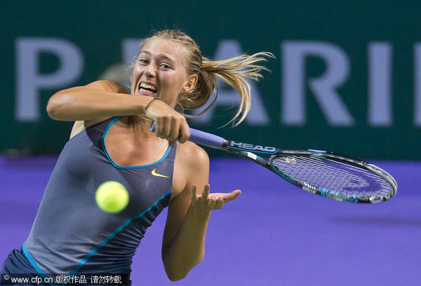 Russia's Maria Sharapova returns to China's Li Na at the WTA Championship finals in Istanbul, Turkey on Wednesday, Oct. 26, 2011.