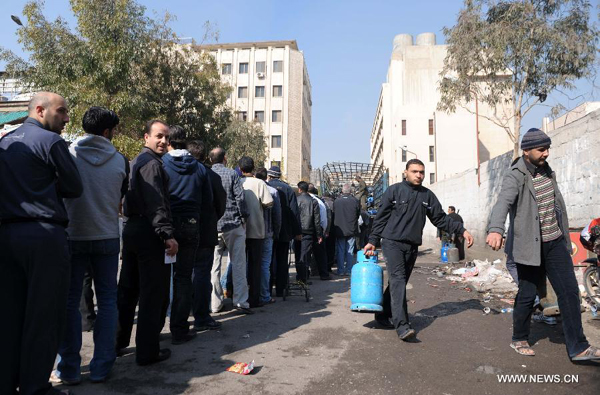 Residents queue up to get gas cylinders at a gas station in Damascus, Capital of Syria, Nov. 27, 2011. Syrians have been suffering from the shortage of cooking gas, due to the months of unrest and economic sanctions imposed by Europe and the United States.