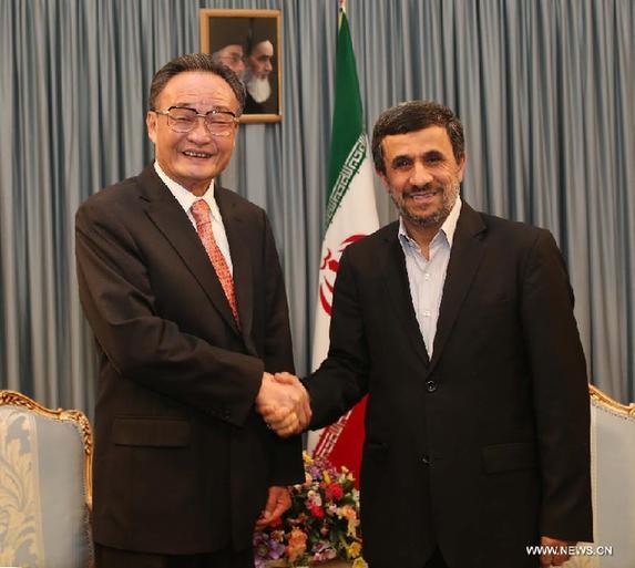 Wu Bangguo(L), chairman of the Standing Committee of China's National People's Congress, shakes hands with Iranian President Mahmoud Ahmadinejad in Tehran, Iran, Sept. 11, 2012. [Liu Weibing/Xinhua]